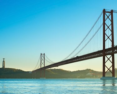 View of 25th of April Bridge at sunset in Lisbon, Portugal